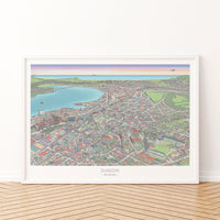 Hand-drawn map art print of Dunedin, New Zealand – detailed pen and digital colour, featuring the Octagon, city buildings, and ocean on the horizon. White framed version for display.