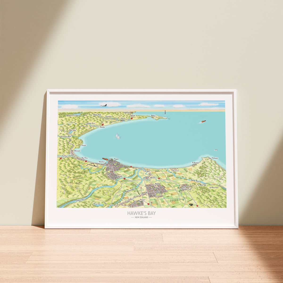 Hand-drawn map art print of Hawke's Bay, New Zealand. Watercolour added for land and digital colours for Ocean. Shows the coastline, vineyards, Napier and towns. White Frame.