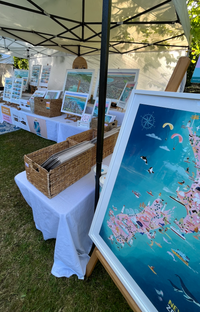 New Zealand map art print hand-drawn in PINK with pastel colours added by digital pencil. Shows little drawings from our travels around the country. White Frame A1 displayed at the market.