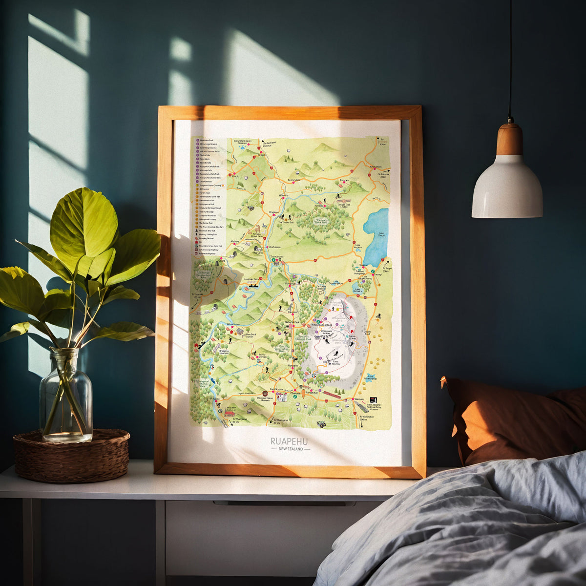 Hand-drawn watercolour map of the Ruapehu region, New Zealand. Shows all the walking tracks, points of interest, roads, and trails across the area. Created as part of a tourist flyer for Ruapehu Council. Detailed and colourful illustration with a love for watercolours. Displayed in wood frame.