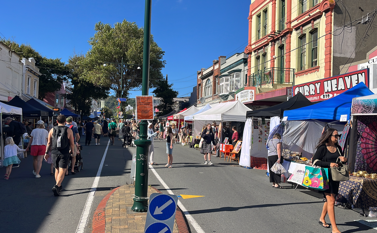Stalls and people walking at Newtown market. 