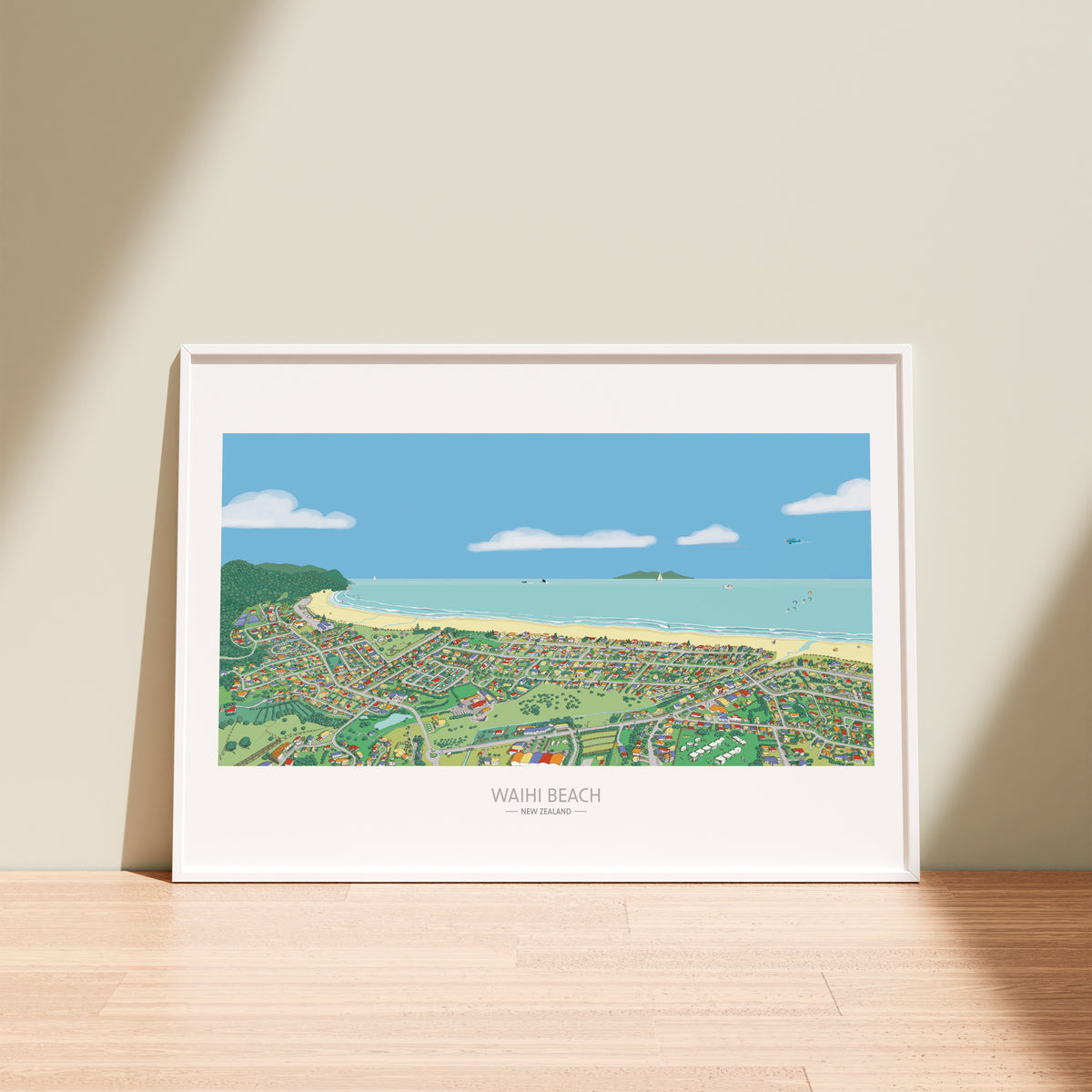 A hand-drawn map of Waihi Beach town, New Zealand. Soft colours added with a digital pencil. Shows the streets, coast, people surfing, boats, and the Sunday market. Displayed in white frame.