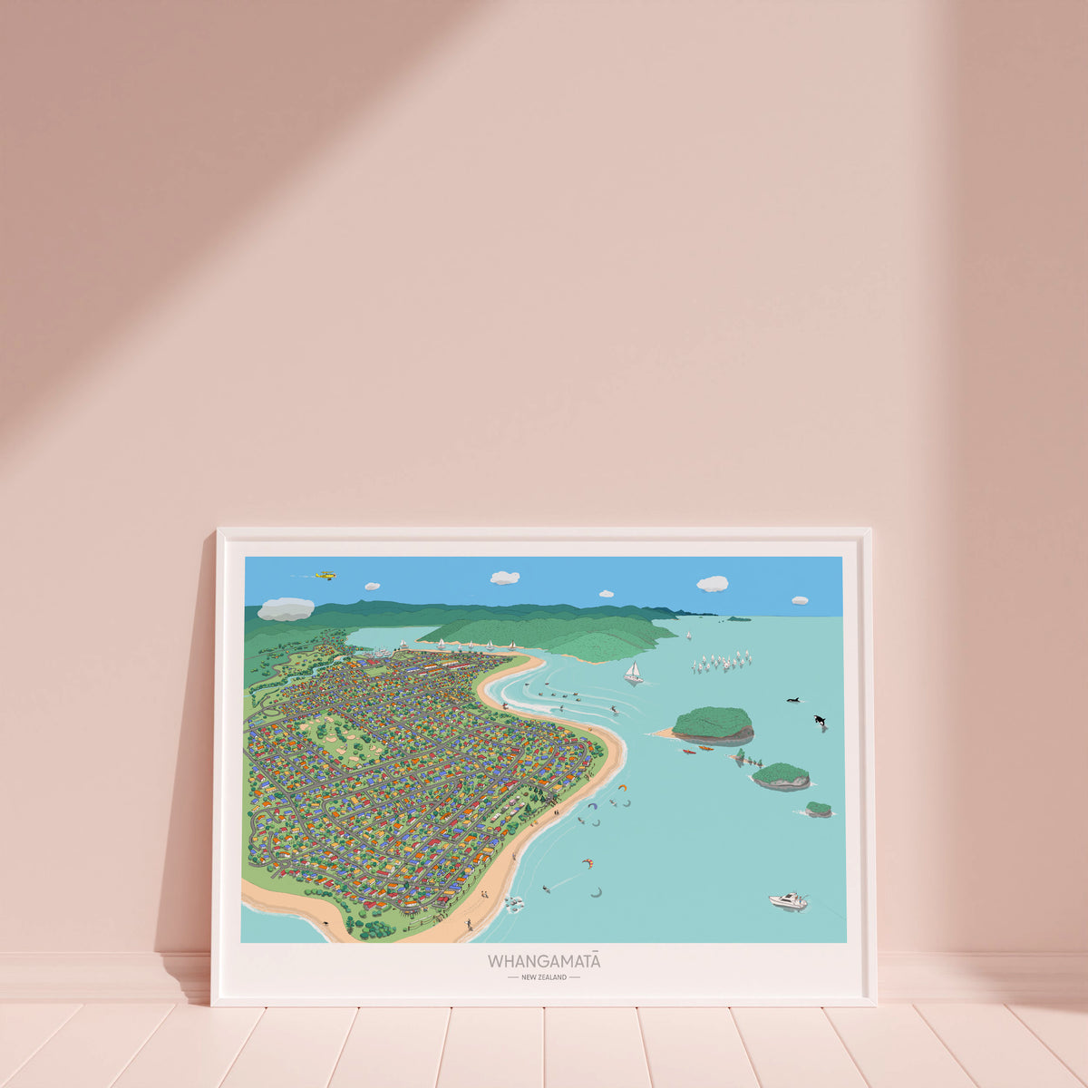 Hand-drawn map art print of Whangamata, New Zealand. Features colourful houses in primary colours, surfer’s paradise beach town vibe. White frame display.
