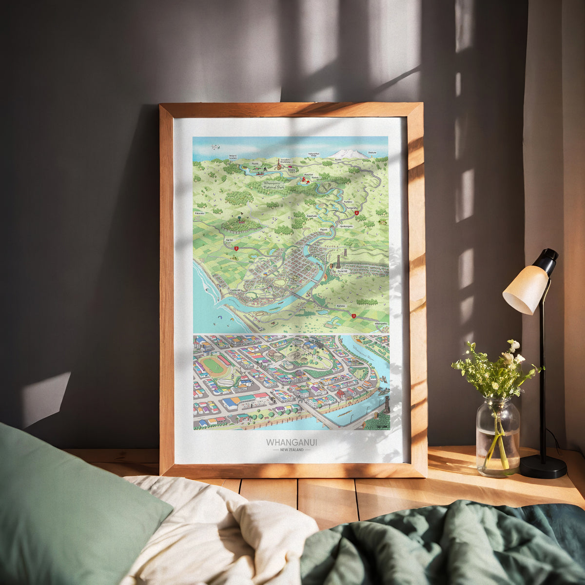 A hand-drawn map of Whanganui art print created in two parts for a District Council project. One part focuses on the city, the other on the wider region of Whanganui, New Zealand. The map highlights the Whanganui River, the Opera House, old houses, the paddle steamer, Durie Hill, the Memorial Tower, and the bridges. Wood framed displayed.